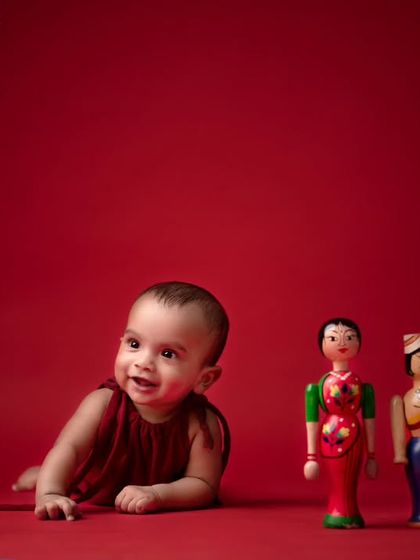 This simple yet charming setup uses traditional wooden toys from "namma ooru" against a bold red backdrop. It's a wonderful way to celebrate our local heritage in your baby's photos.