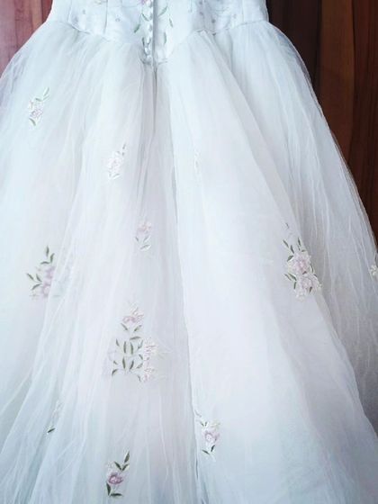 A closer look at the delicate floral embroidery on the tulle skirt of this unique white gown.