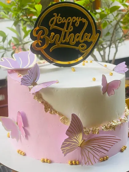 A lovely pink and white butterfly cake, perfect for a simple, elegant celebration.