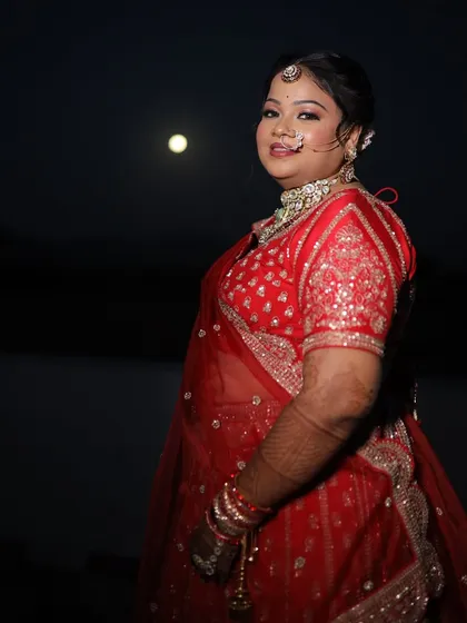A stunning night shot of the bride. Her makeup remains fresh and radiant, proving its longevity throughout the long wedding day.