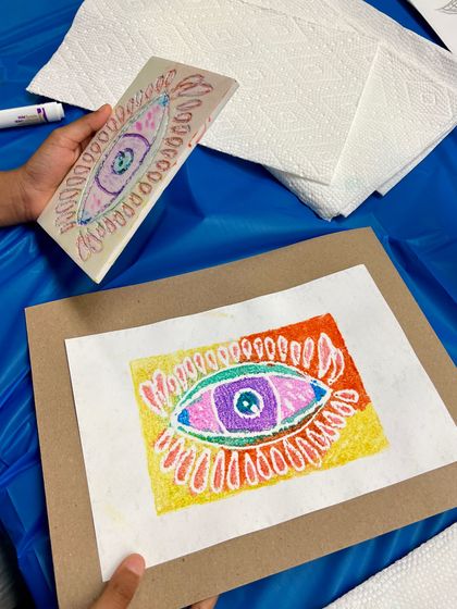 An intricate eye design, showing both the colored foam plate and the final, colorful print.