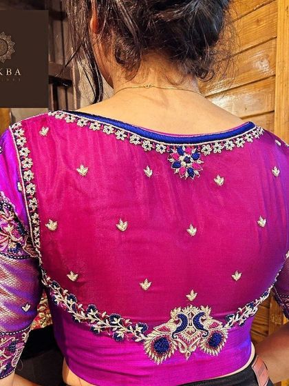 A sheer back blouse in a striking magenta. I used delicate floral buttis and a heavy border of zardosi work with peacock accents to create a piece that is both elegant and modern.