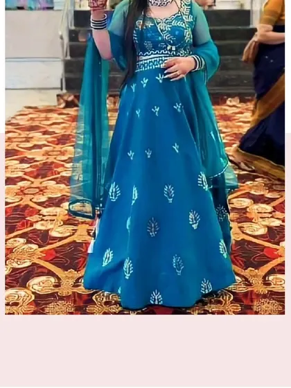 This client looks beautiful in a teal blue lehenga with delicate white embroidery. It's a unique color that is sure to make you stand out.