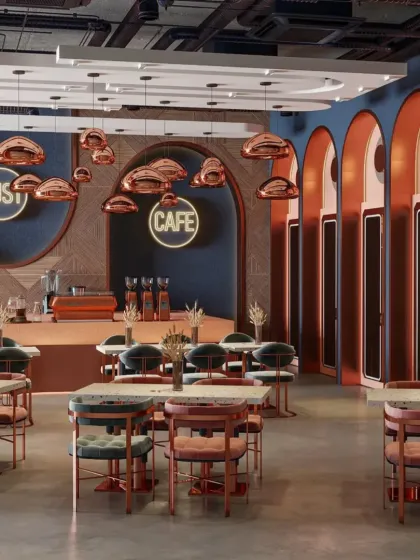 The front view of the cafe, highlighting the branding and the cohesive color story that runs through the furniture, lighting, and architectural details.