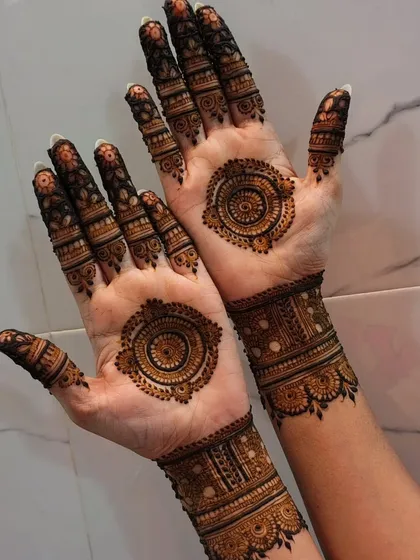 The same mandala design, but on the palms. The intricate circles are framed by a simple wristband and detailed fingertips, creating a balanced look.