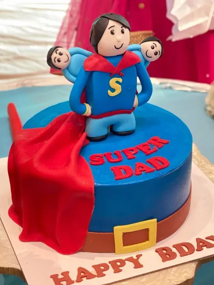 Another angle of the Super Dad cake, showing off the flowing red cape and custom details. It's a fun way to celebrate a father's birthday.