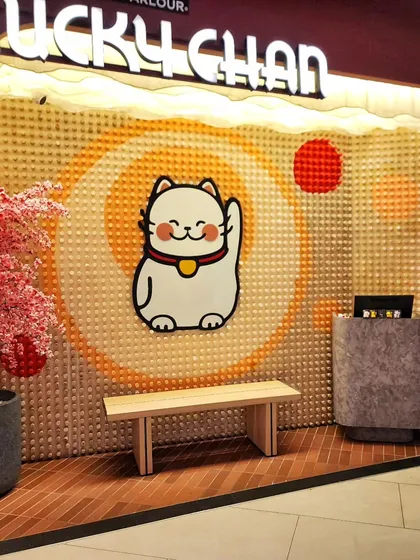 For the entrance of Lucky Chan, we created this textured backdrop for their iconic waving cat logo. The entire piece is made from 1,408 hand-painted wooden pegs, showing how we love to experiment with different materials to create something unique.