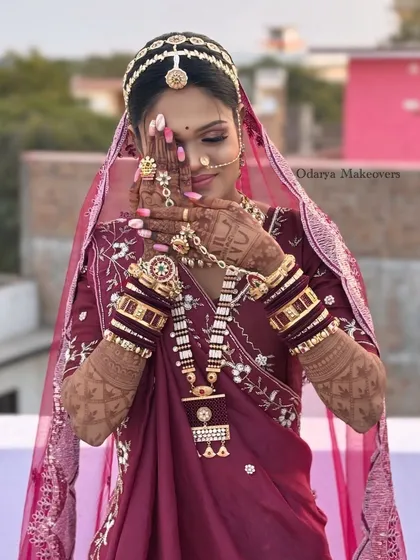 The quintessential shy bride pose, showcasing the intricate henna and stunning bridal jewellery. The makeup is set perfectly to last through all the ceremonies and emotions of the day.