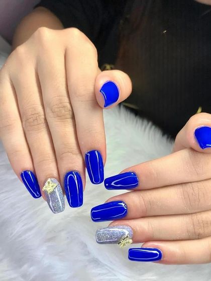 A bold set of royal blue square extensions with a silver glitter and rhinestone accent nail.