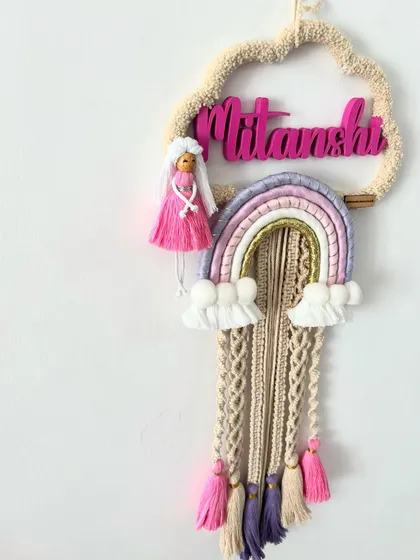A side view of the 'Mitanshi' name hanging, showing its depth and the different layers of the design.