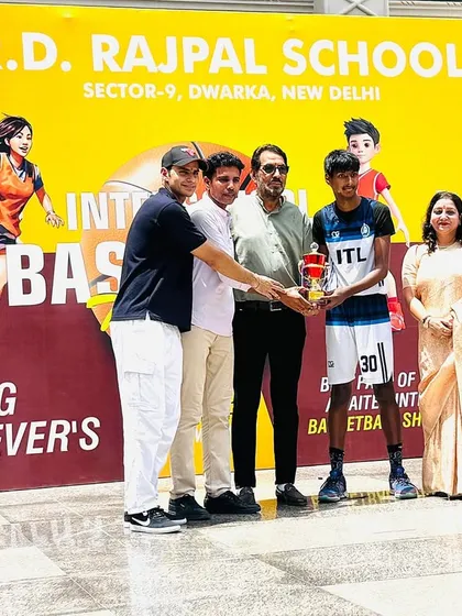 A proud moment receiving the championship trophy at the Young Achievers Tournament. Moments like these are what we train for, validating all the hours of practice.