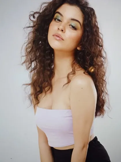 A pop of color on the eyes combined with fresh, dewy skin. This look is perfect for a youthful fashion brand or a model's portfolio, showing a hint of playful color.
