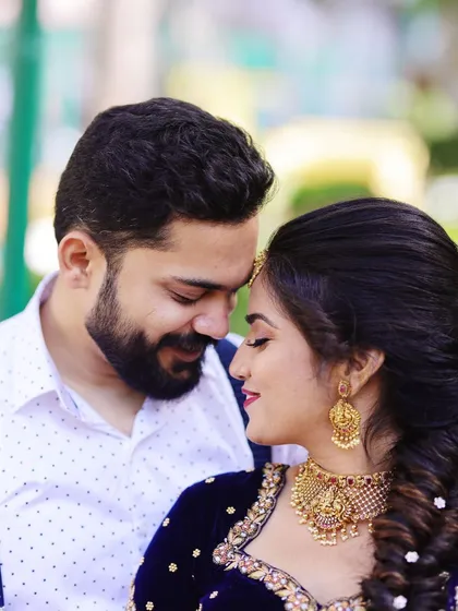 A beautiful moment between the happy couple. Our client looks lovely in a classic temple choker set that perfectly complements her navy blue and gold lehenga. We believe our jewellery is part of your story, and we are so happy to be a part of moments like these.