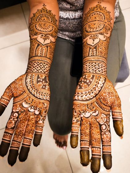 A complete bridal look, with intricate henna from the fingertips to the elbows.