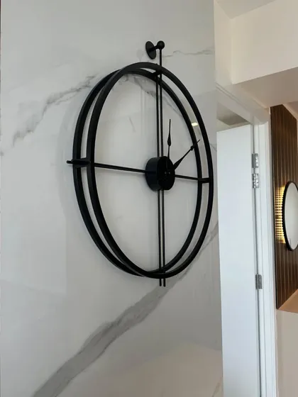 Seen here in a home setting, the large minimalist wall clock makes a statement without overwhelming the space. Its timeless design integrates seamlessly into a modern entryway, adding both function and style.