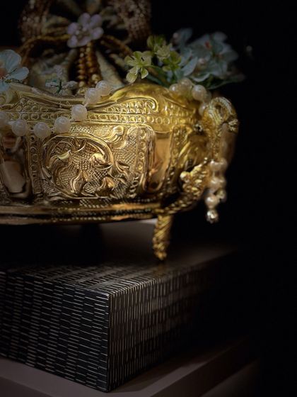 A dramatic, close-up shot of the ornate golden bowl, highlighting the detailed craftsmanship and luxurious feel.