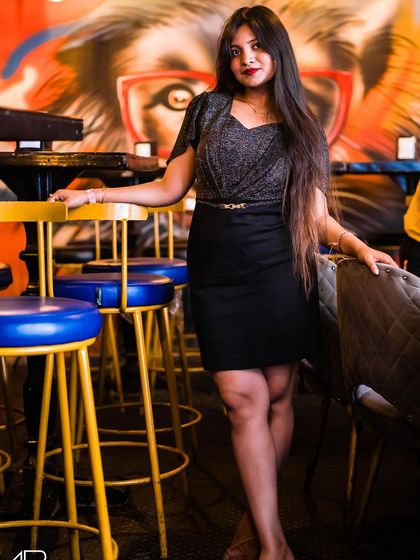 A guest posing on a bar stool.