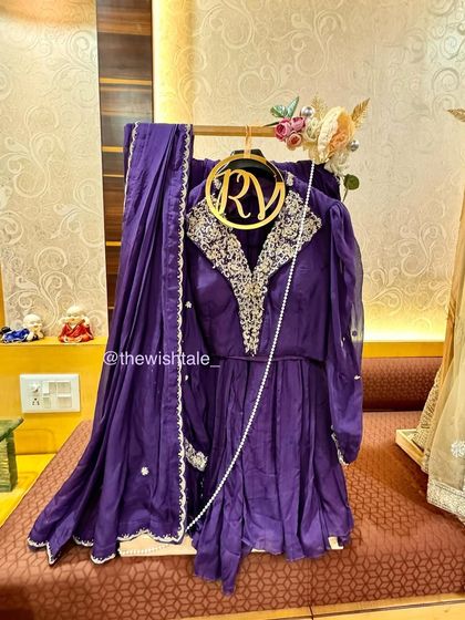 A royal purple suit set, elegantly draped and ready for gifting. I use custom hangers and stands to ensure the outfit's shape and embroidery are perfectly showcased as part of the wedding trousseau.