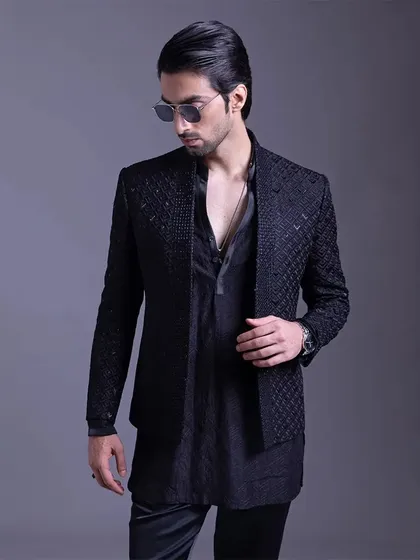 Every detail counts. This black-on-black textured jacket and kurta combination is a story of modern sophistication, perfect for the man with a timeless sense of style.
