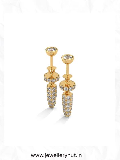 These unique drop earrings feature a textured, sparkling design that catches the light beautifully. They are perfect for adding a sophisticated touch to any outfit.