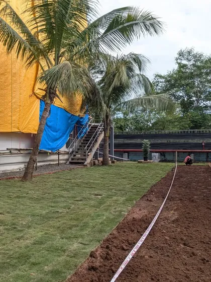 A measuring tape is used to ensure straight lines and precise borders for the new lawn area.
