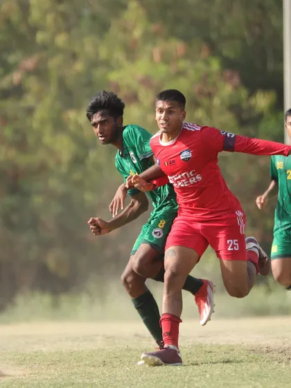 A player in full stride during a competitive match, demonstrating the speed and athleticism we develop in our athletes.