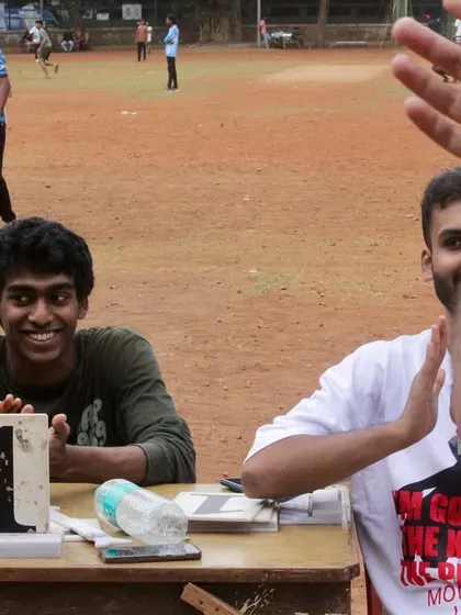 Our scorekeepers at the table, smiling and clapping. Even our volunteers are fully invested in the game's energy.