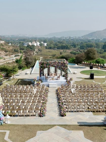 Another wide-angle view showing the relationship between the ceremony space and the surrounding landscape. The design respects and enhances the natural beauty of the destination.