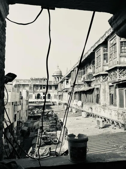A view from a window looking out over the rooftops and courtyards of a historic haveli.