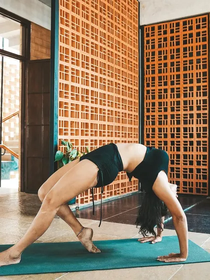 This is a duplicate of image 15. A student holds a graceful wheel pose, showcasing the strength and openness that our training helps to develop.