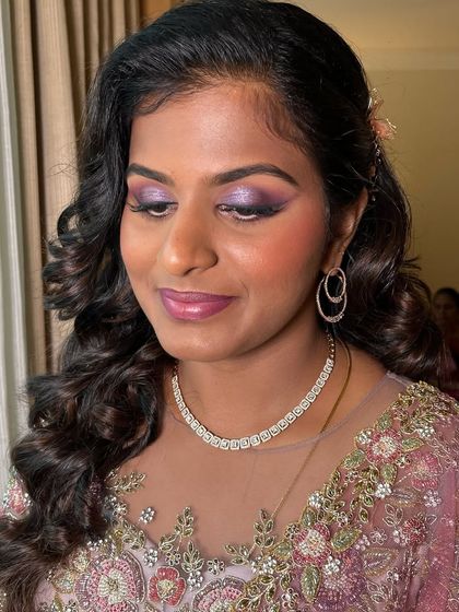 For Akshaya's reception, we went with dreamy lilac eyes and ombre pink lips. The purple tones on the eyes were chosen to complement her beautiful lilac outfit.