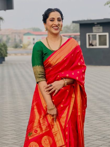 Another elegant pose in the beautiful red Paithani saree.