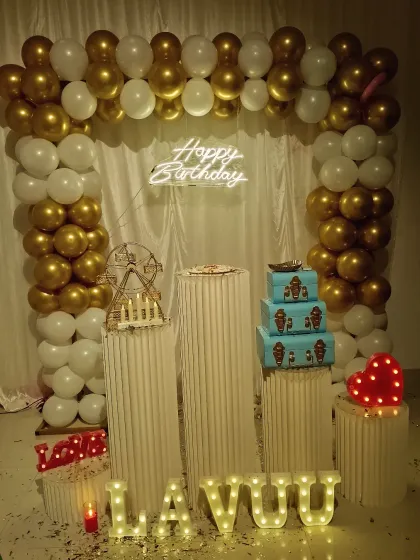 A beautiful white and gold balloon arch setup. This package includes the decoration, private theater use, cold fire, and speakers for a complete party experience.