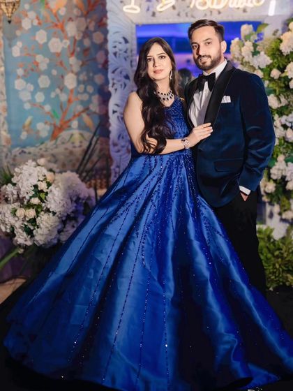 The couple, looking like a vision. Her blue gown and his velvet tux are a perfect match.