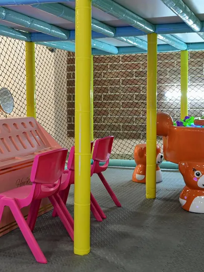 A view of our soft play area, with bear-themed chairs and other toddler-safe equipment, all enclosed within the main structure.