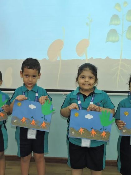Another group of young learners proudly presents their seed germination crafts, demonstrating what they've learned about nature.