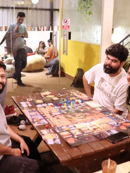 A table deep in the world of a complex board game. We love hosting serious gamers and providing a space for epic sessions.