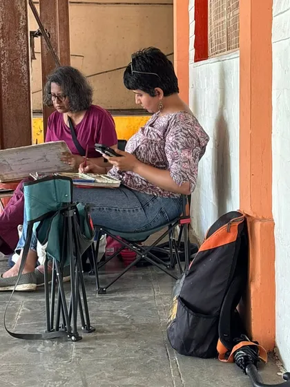 A candid shot of me and another artist sketching side-by-side. My workshops are very collaborative, and we often learn just as much from each other as we do from the scenery.