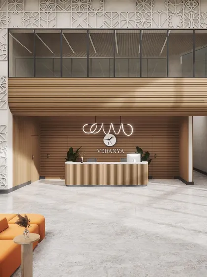 A render of the reception area for Vedanya School. The design blends functionality with inspiration, using warm wood tones, modern lighting, and intricate wall patterns to create a welcoming space that sparks curiosity.