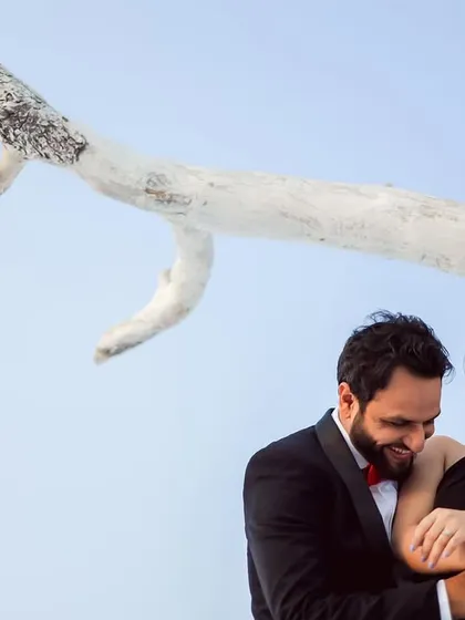 A moment of shared laughter during a stylish pre-wedding shoot. Even in a formal setting, I look for the candid interactions that show the couple's genuine joy and connection.