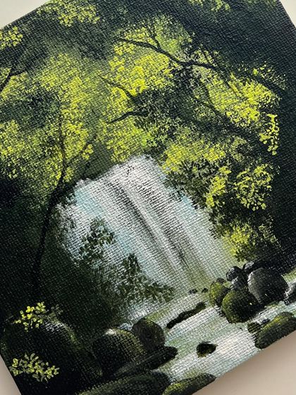 A detailed close up of the small waterfall painting, focusing on the light and shadow.