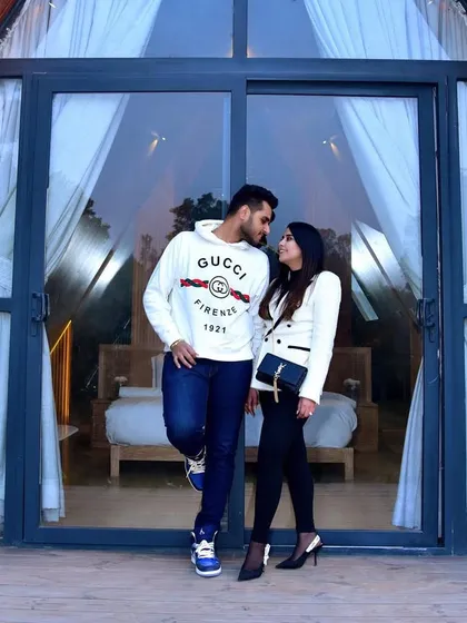 A stylish pre-wedding couple shoot set against a modern A-frame cabin. This image captures a genuine, intimate moment and demonstrates our skill in creating lifestyle portraits for couples in unique locations.
