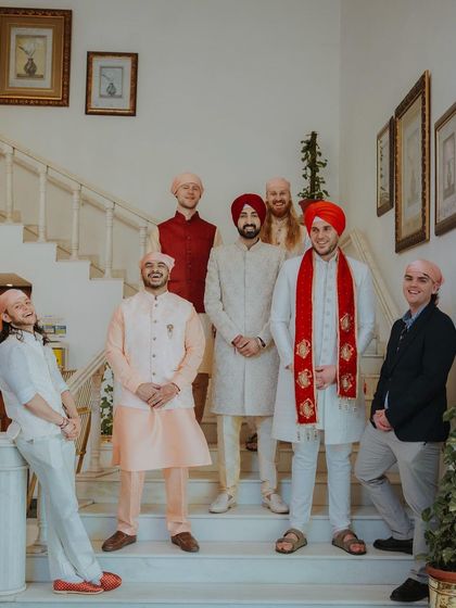 A fun and relaxed group portrait of the groom with his groomsmen on a staircase.