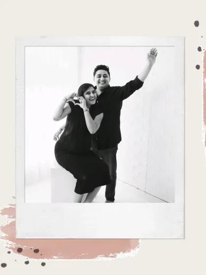 A fun and candid black and white shot with a polaroid frame effect. This couple's playful wave makes for a joyful and memorable maternity photo.