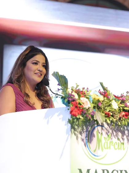 A smiling shot from the podium, connecting with the audience.