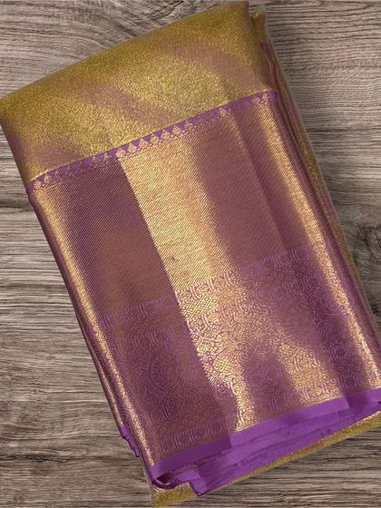 A classic purple Kanchi silk saree with a heavy gold brocade border and pallu.