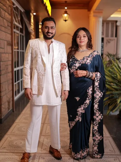 A full-length shot showcasing the graceful fall of the blue embroidered saree.