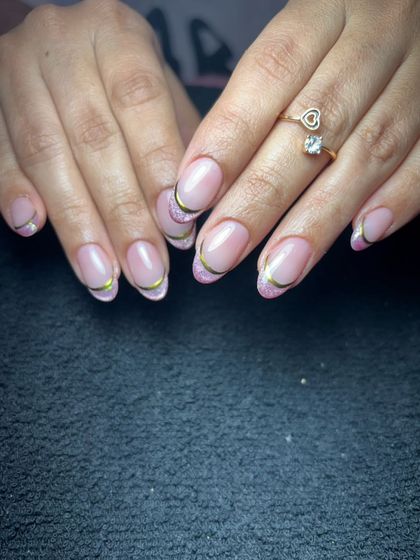 A simple and clean French manicure with a thin gold line for a touch of elegance.
