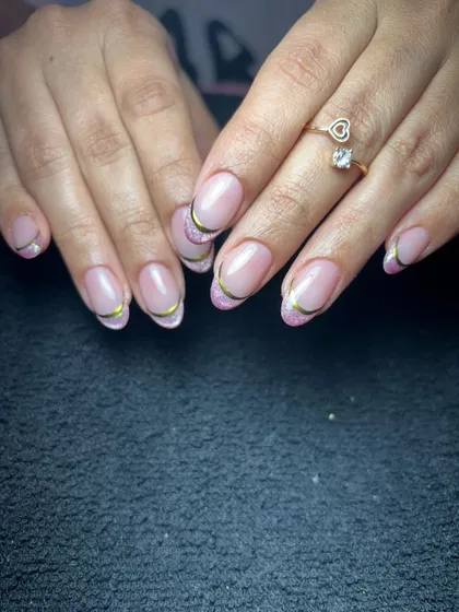 A simple and clean French manicure with a thin gold line for a touch of elegance.