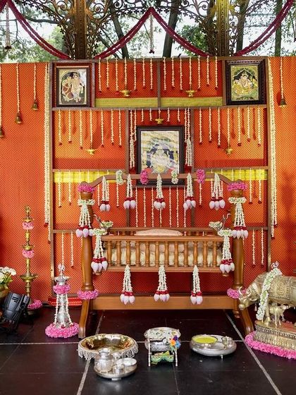 A beautiful setup for a traditional naming ceremony, with a decorated cradle (thottil) and offerings, held at our Bandstand.